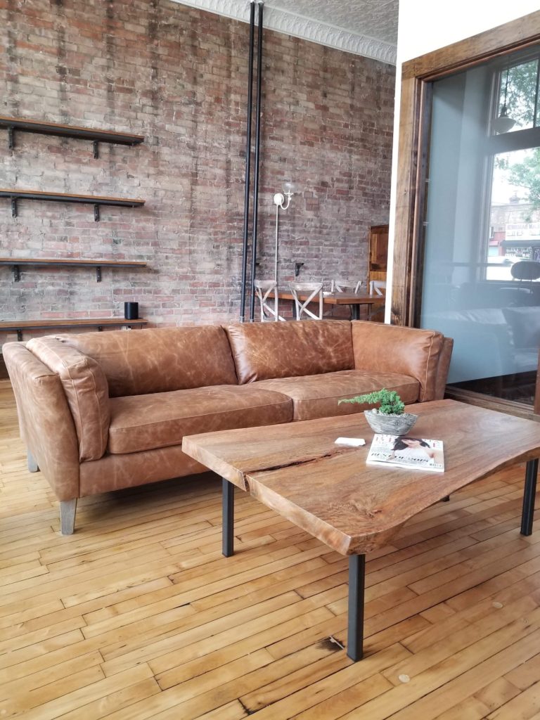 Sitting Area with Live edge table and leather chair at Cornerstone Studios