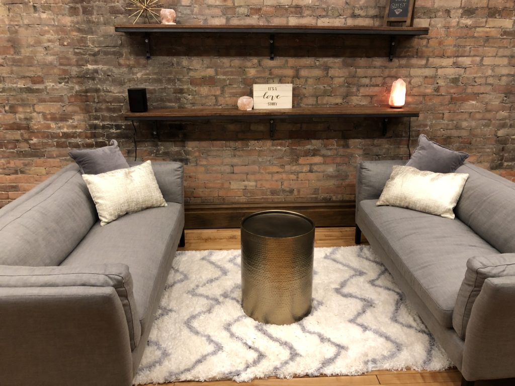 Sitting Area in Cornerstone Studios with two couches and shelves
