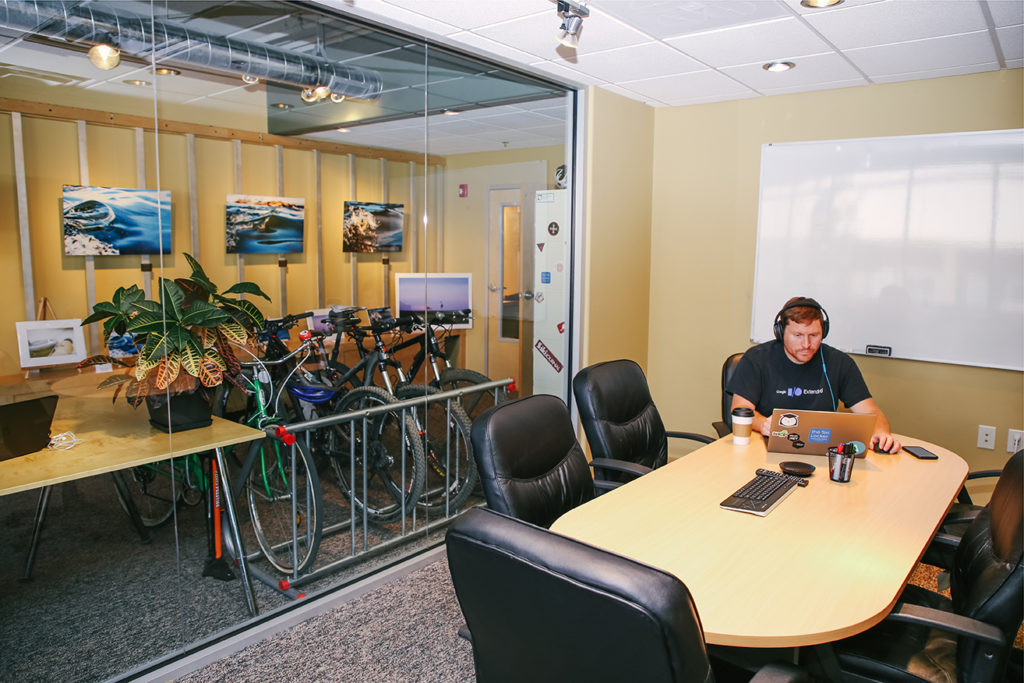 Coworker and bikes in conference room