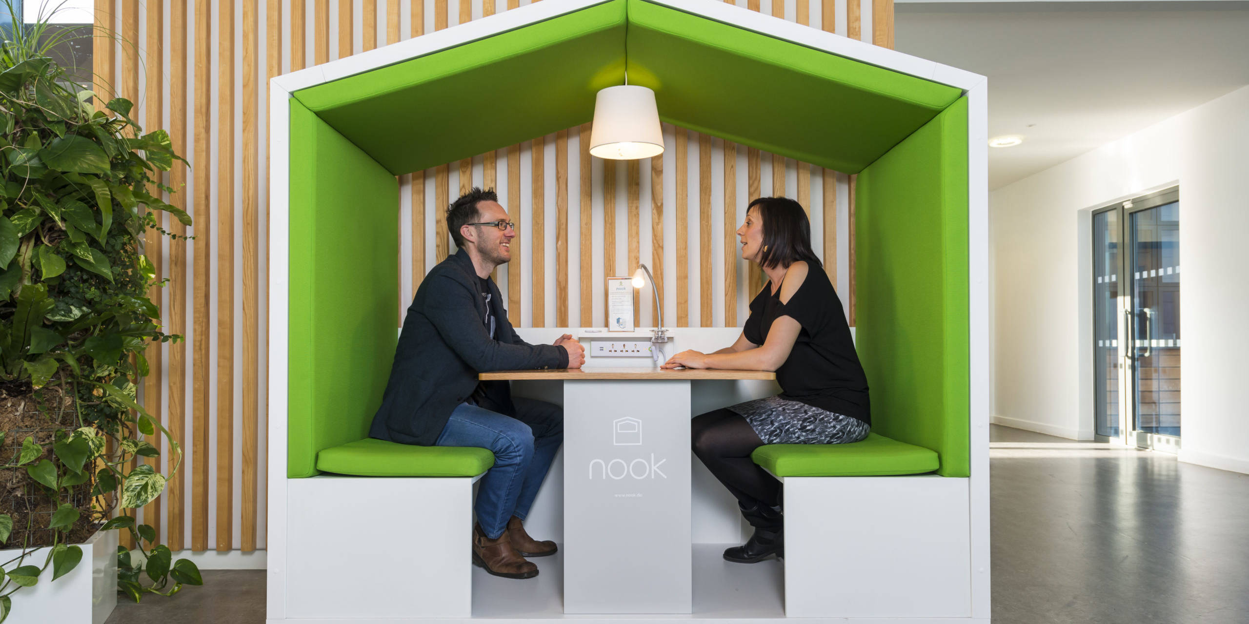Coworkers working out of a Nook Pod