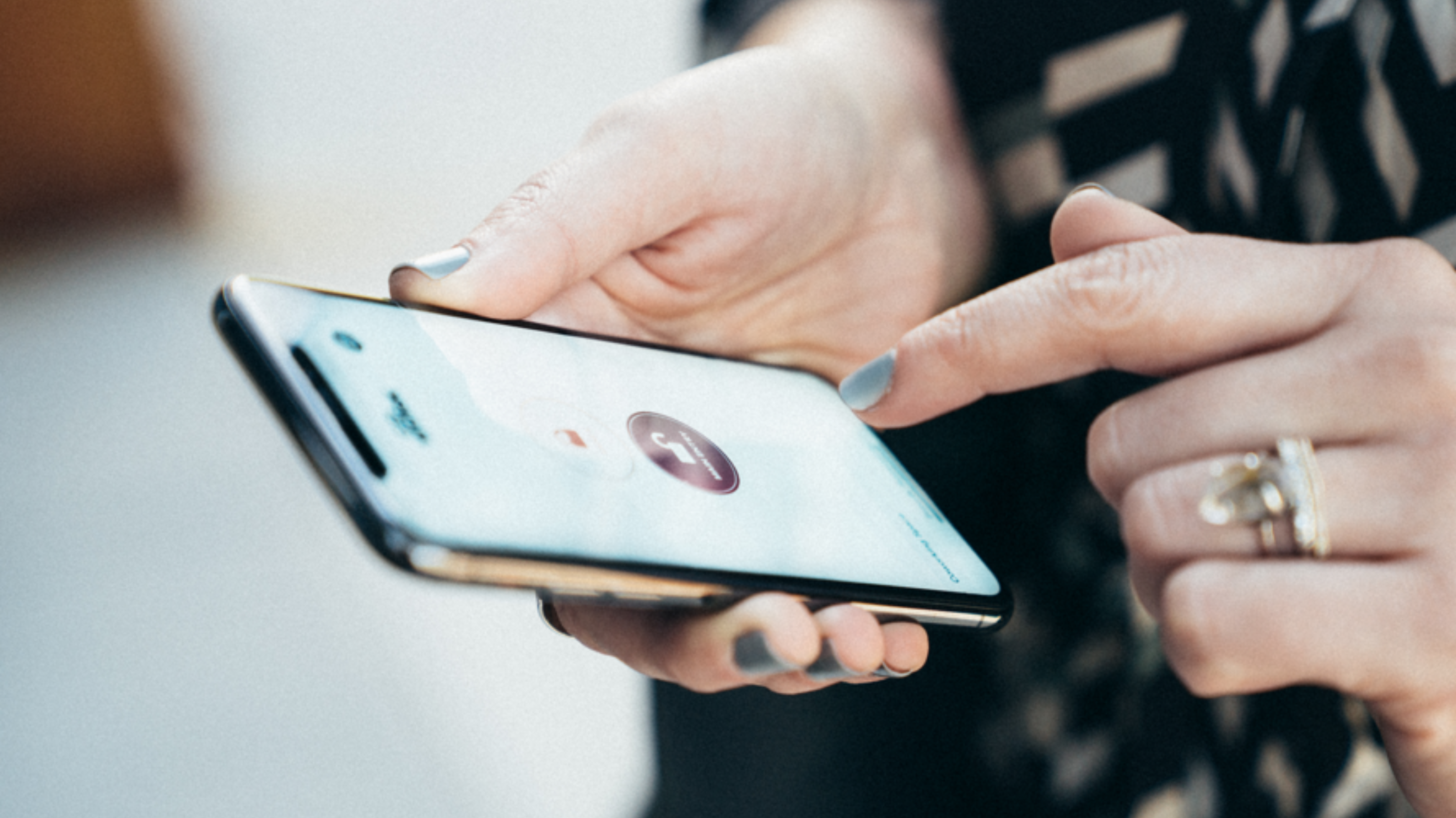 Picture of hands holding phone to securely unlock a building or office door via app